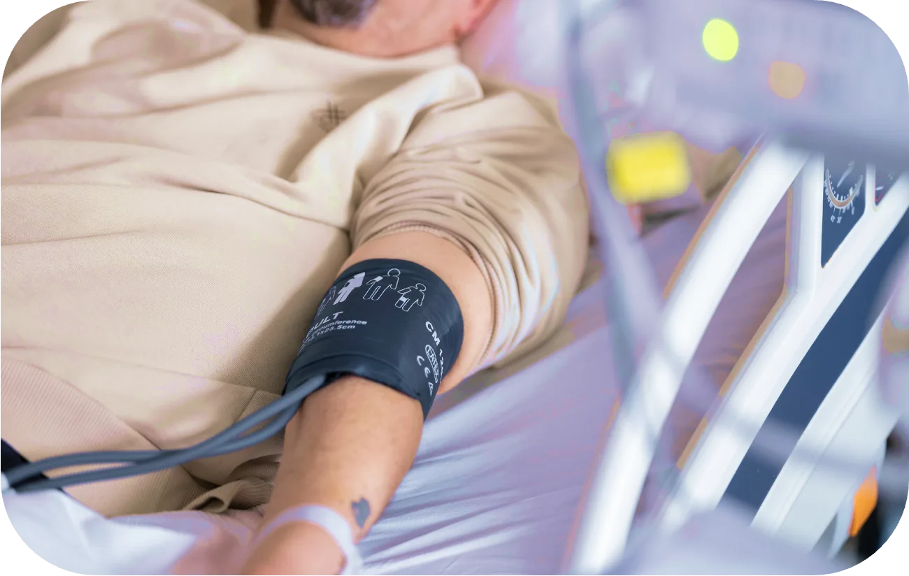 Patient connected to a blood pressure cuff during a hospital monitoring session