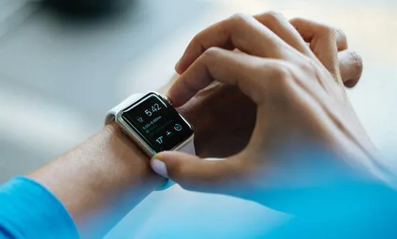 Person checking a smartwatch on their wrist